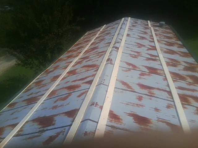 Rusted metal roof panels with new wood purlins before replacement — Storm Damage Roof Repair in Downers Grove by Roofing Brothers