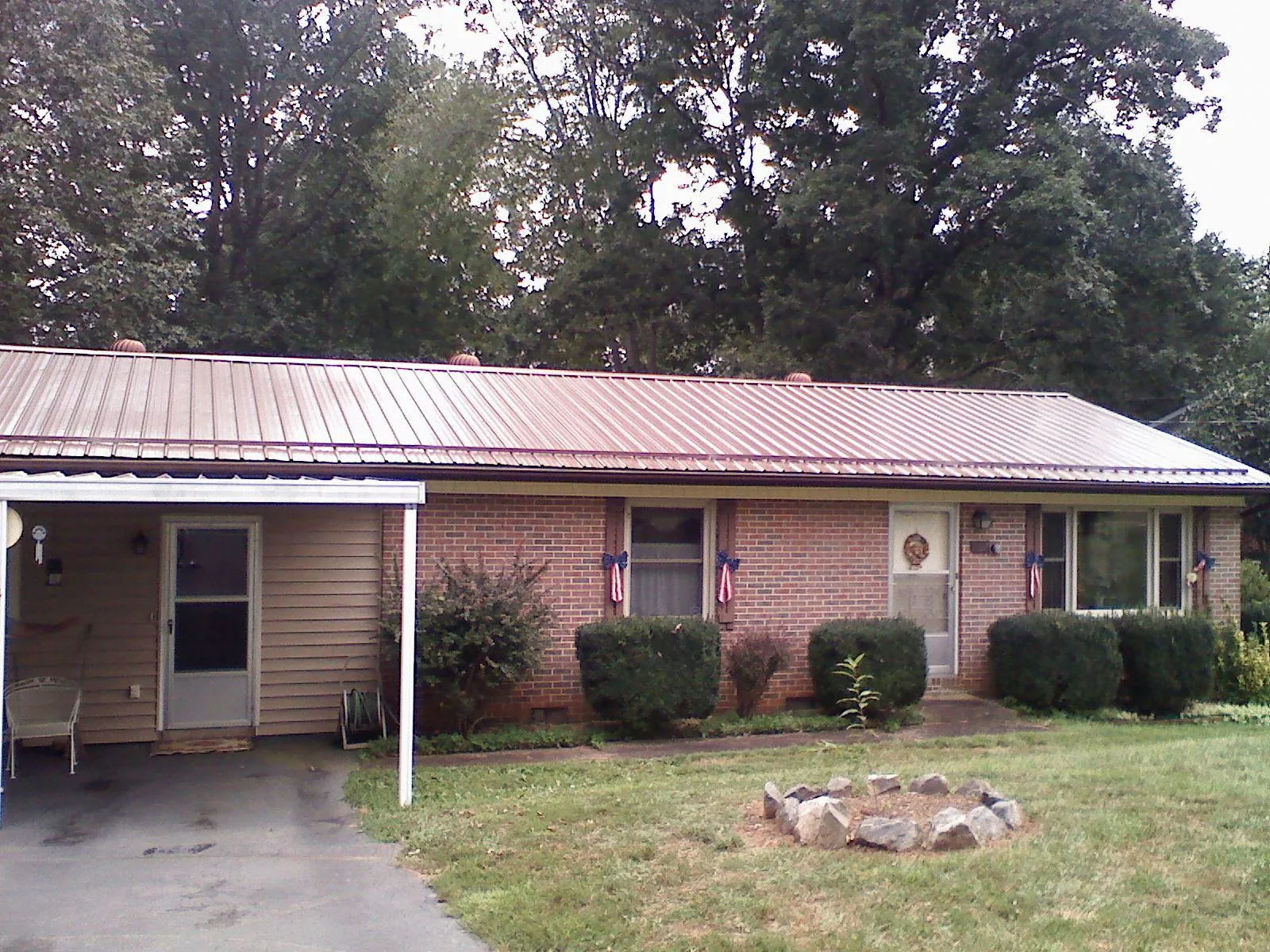 Bronze metal roof and carport on a brick ranch home — Roof Repair work by our crew in Downers Grove